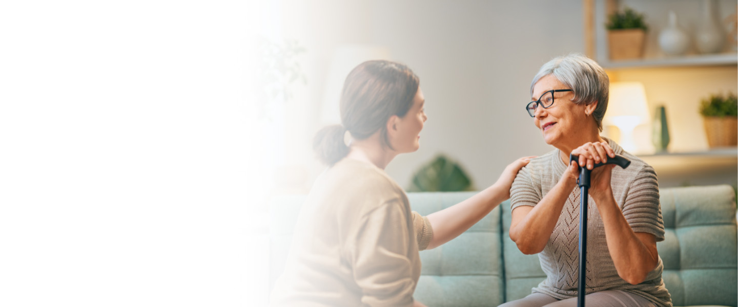 Elderly woman comforted by caregiver Service Area