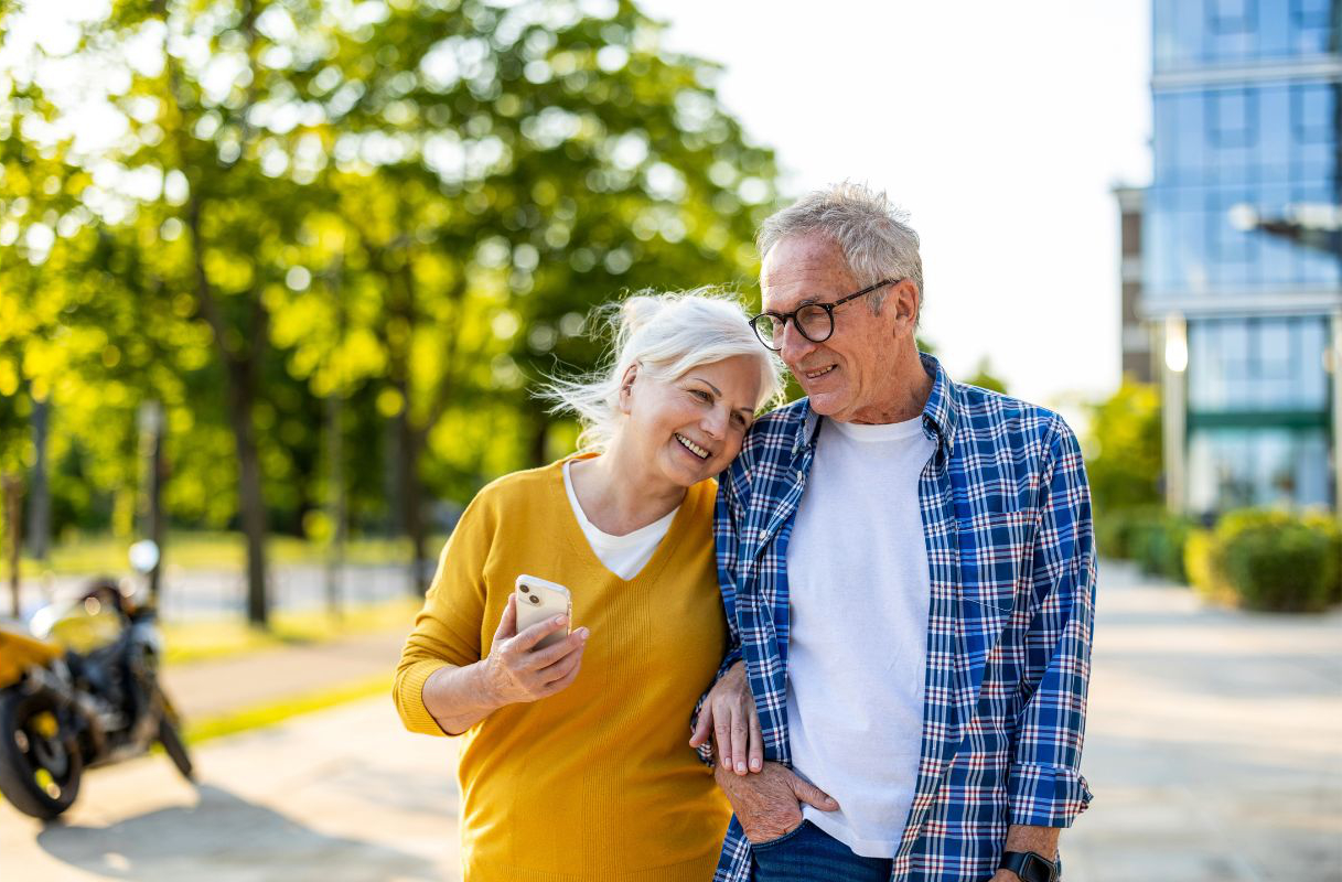 Smiling senior couple walking together outdoors Smiling senior couple walking together outdoors