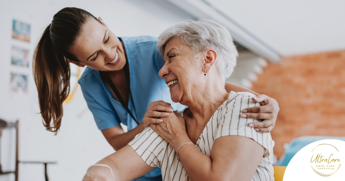 A female caregiver helping an older woman with stroke recovery at home.